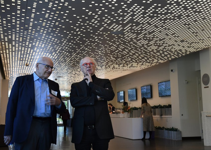 The two architects whose designs were used to restore and renovate the Martin Building at the Denver Art Museum, Curtis Fentress of Fentress Architects, right, and Jorge Silvetti of Machado Silvetti, pause for a moment near the main entrance of the building.